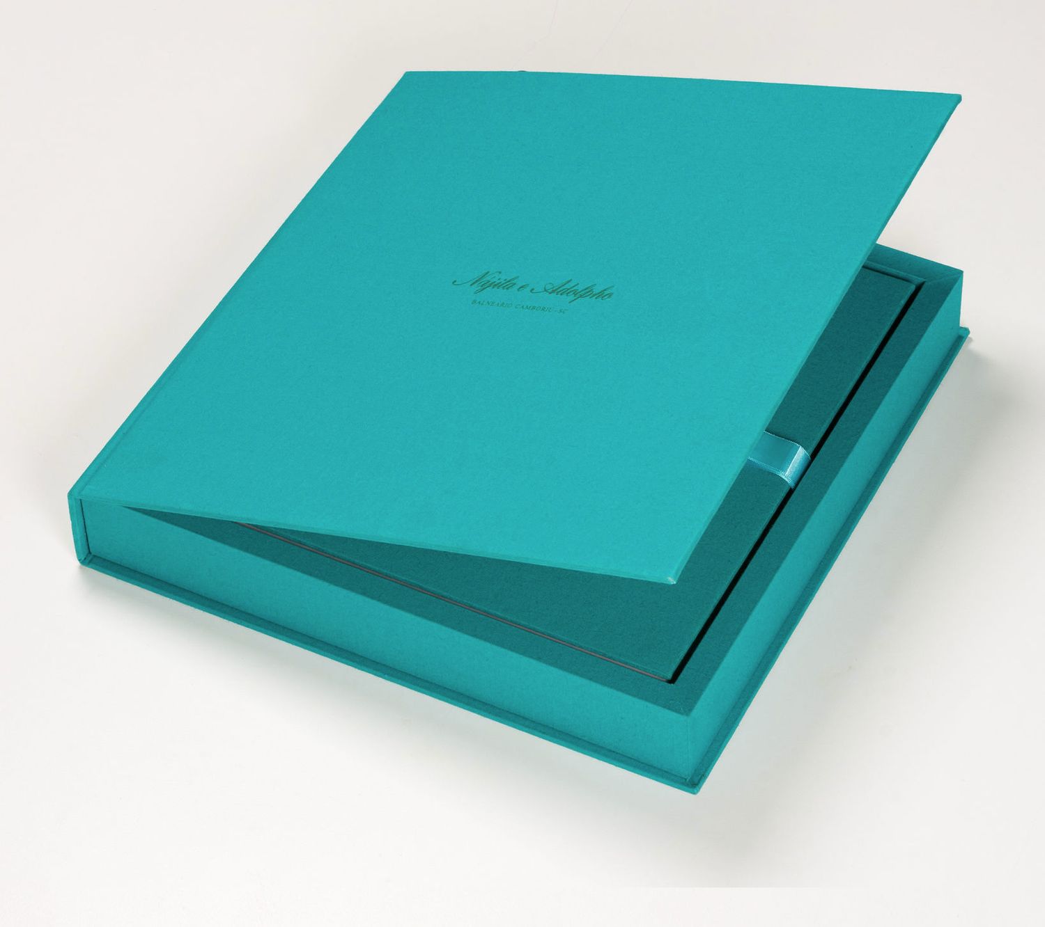 Teal turquoise luxury photo album box with matching cover, featuring elegant script text on a white background.