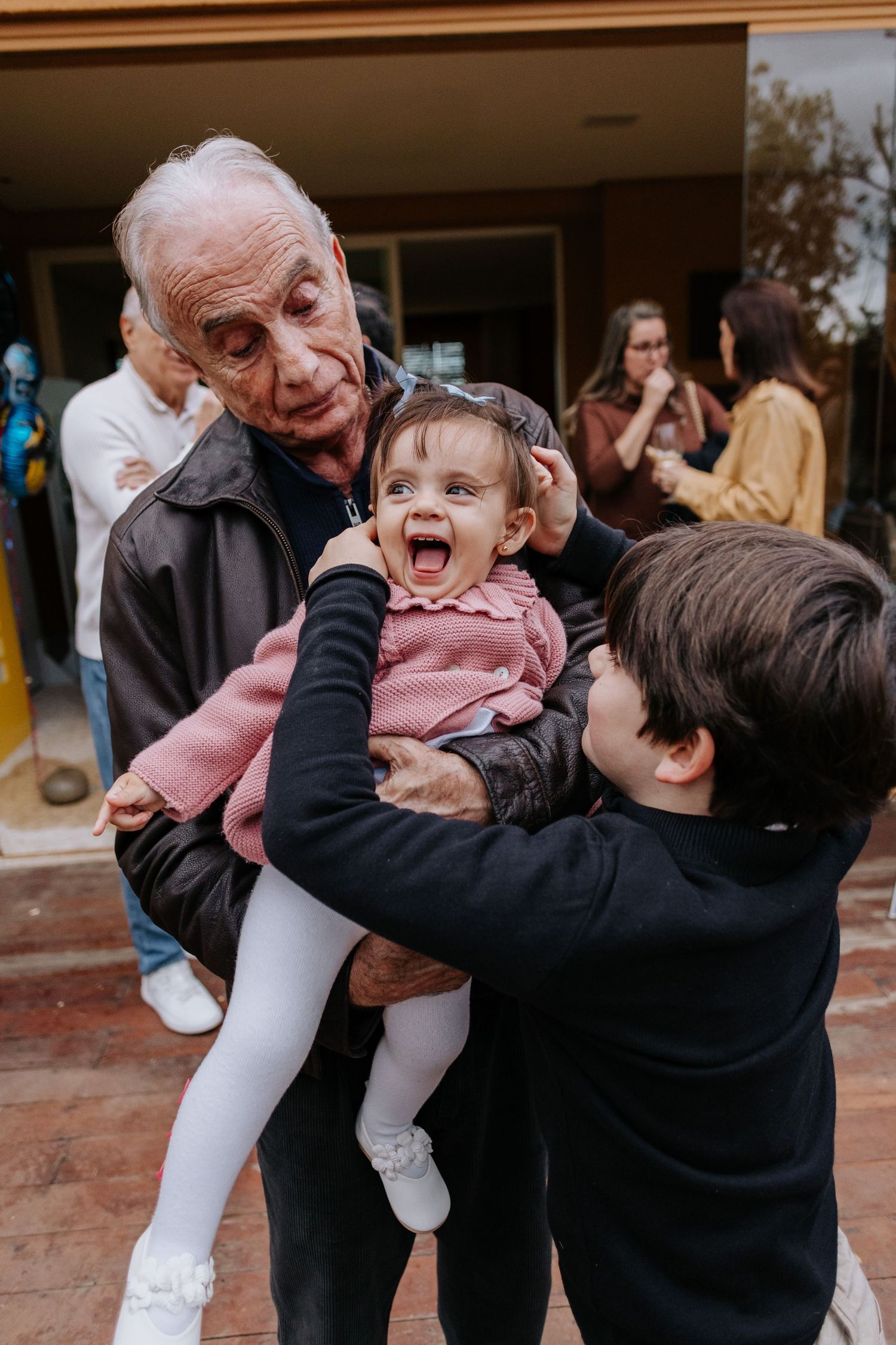 A joyful sequence of candid moments showing a child and elderly person playing and laughing together outdoors.