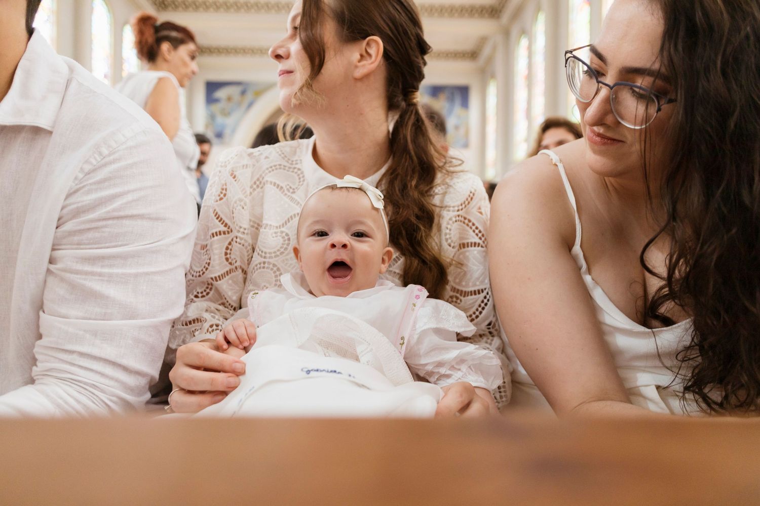 A tender moment during a baptism ceremony inside an ornate church.