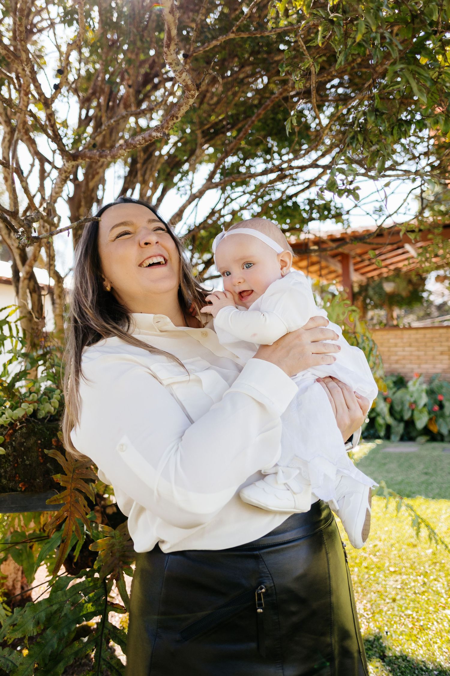 Playful outdoor photo series showing happy moments between parent and baby against a natural backdrop.