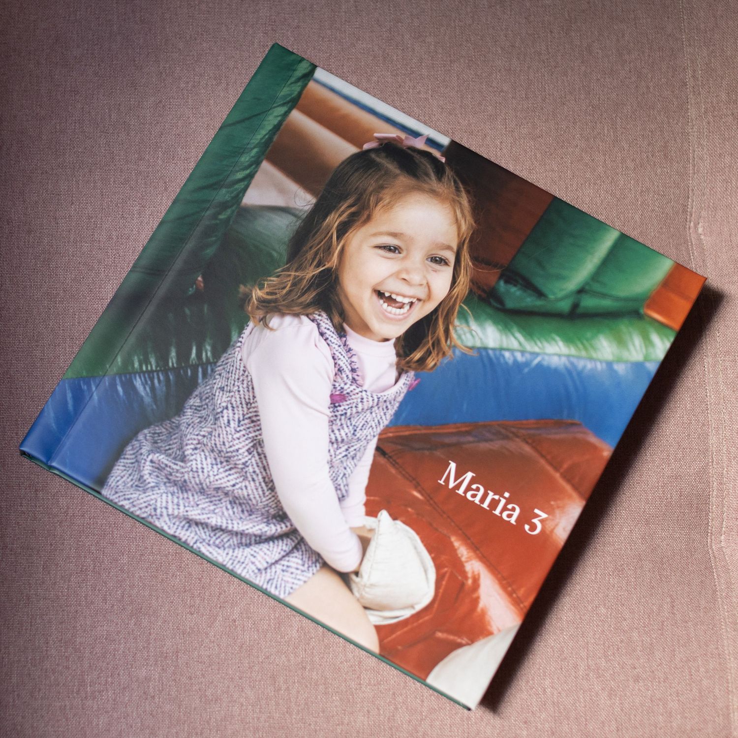 Personalized photo book cover featuring a smiling young girl named Maria, celebrating her 3rd birthday.