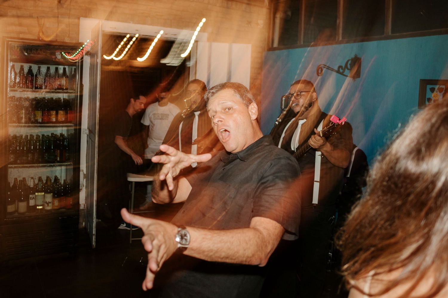 Person making expressive dance moves in indoor space with motion blur effects.