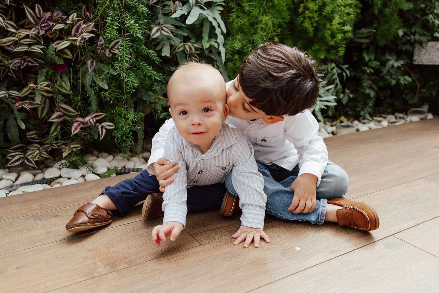 A series of photos showing a baby crawling on a tiled floor next to someone in jeans and brown shoes.