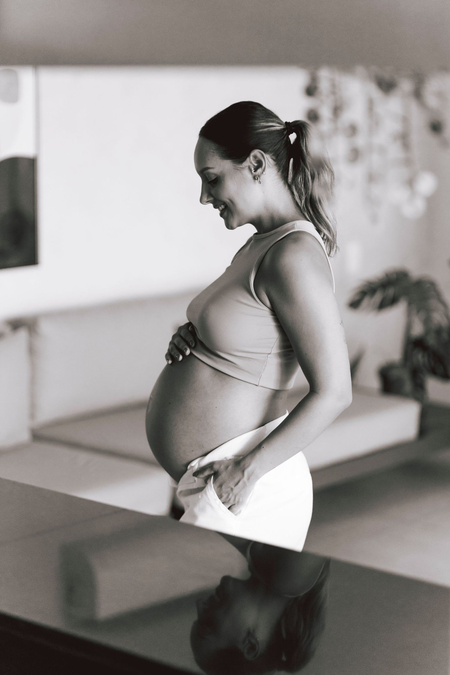 A black and white series showing the progression of a pregnancy over time through side profile images.