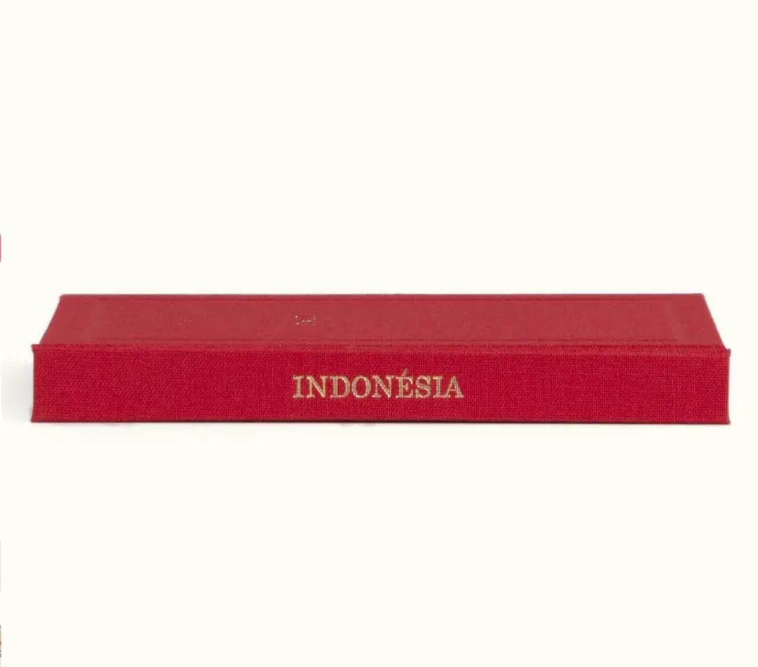 Red hardcover Indonesia stamp album box with gold embossed lettering, ideal for philatelic collections.
