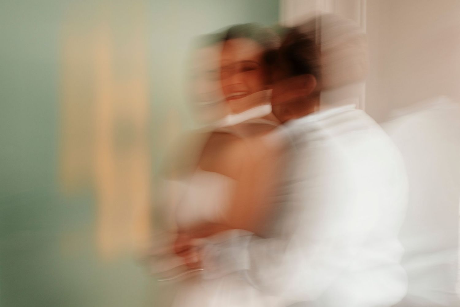 Blurred motion shot of someone in white creating an artistic ethereal effect.