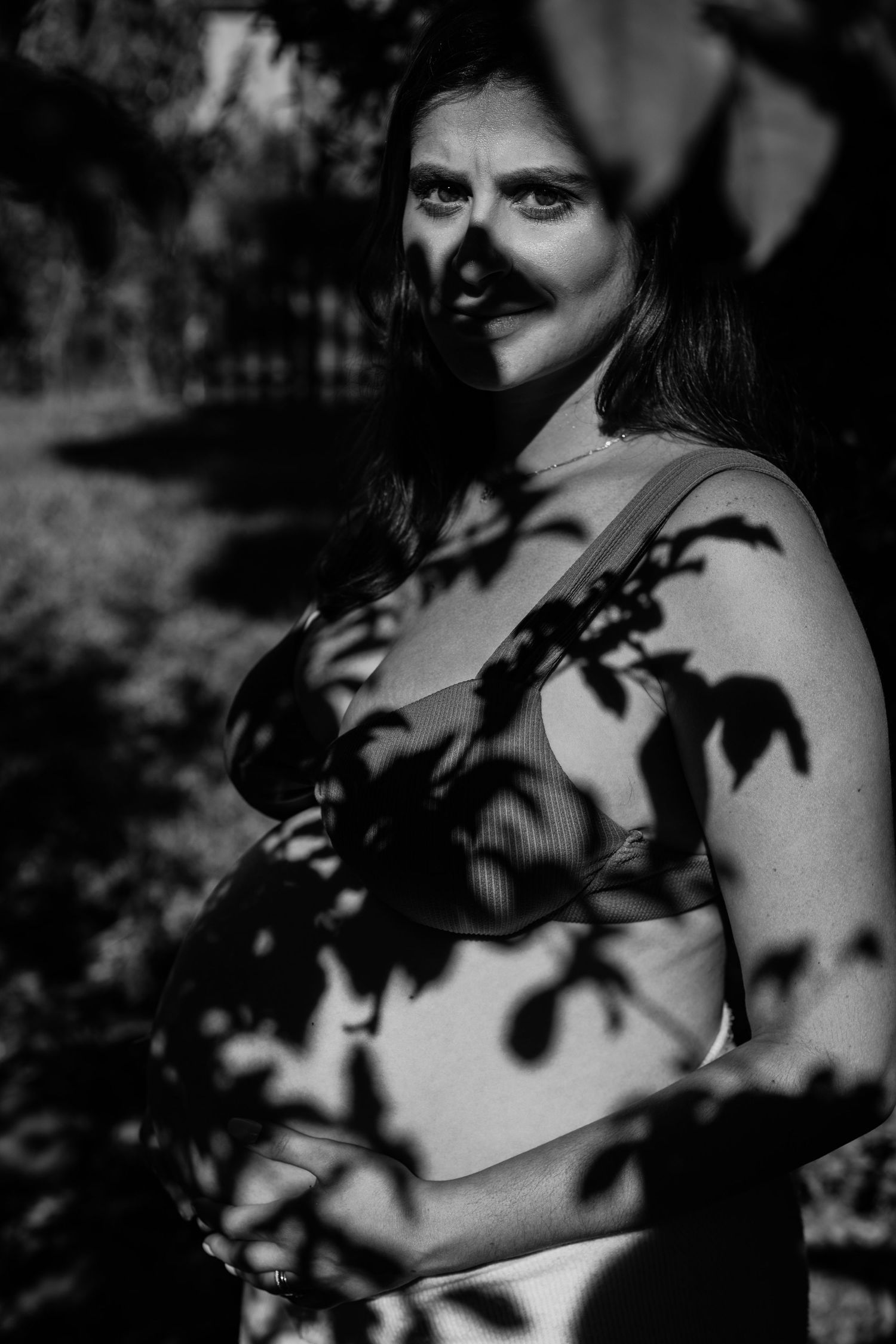 Black and white artistic photography series featuring shadows of leaves cast on skin in a sensual, moody style.