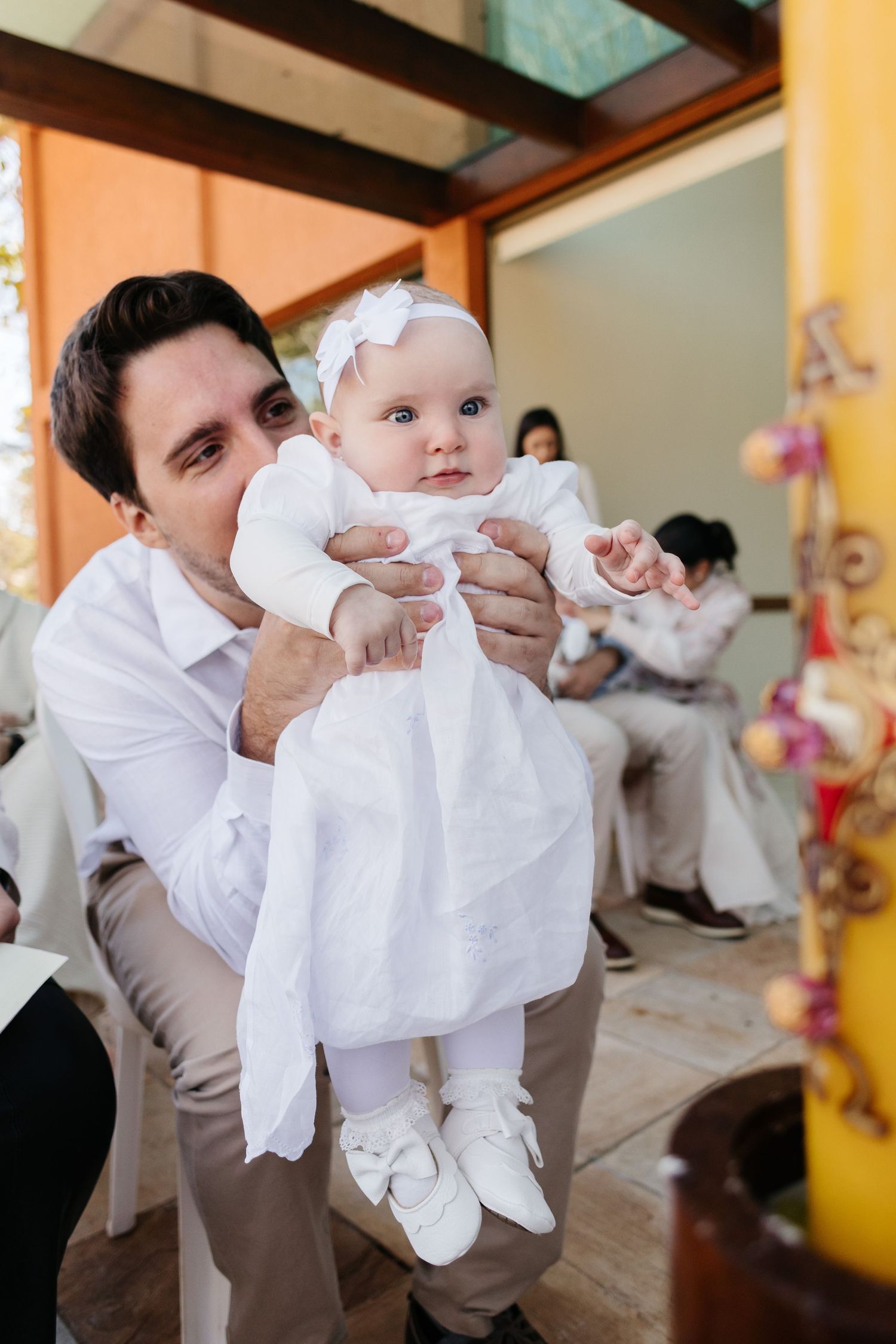 Series of candid photos showing a parent in white shirt holding and playing with a baby indoors.