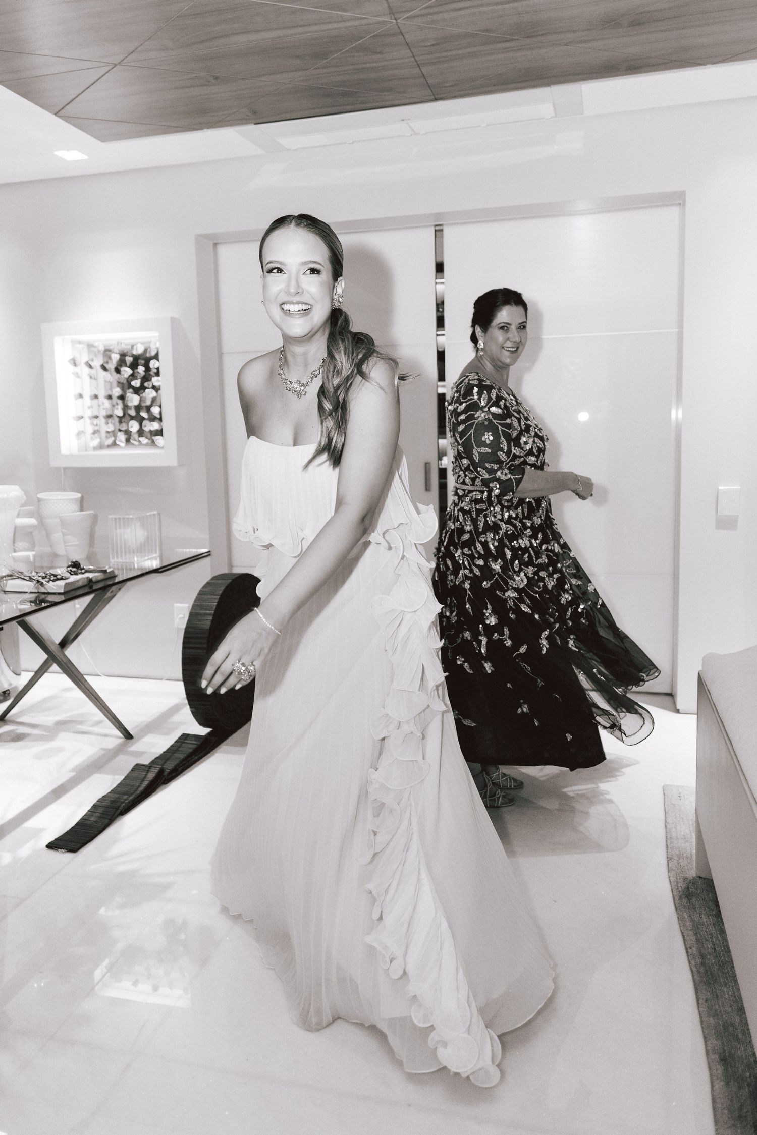 Bride getting ready sequence showing dress and shoe preparation in bright indoor setting.