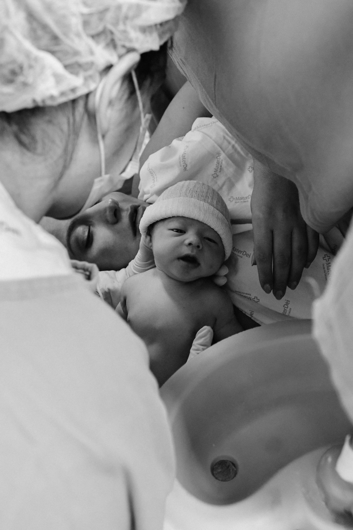 Medical team attending to newborn baby immediately after birth.