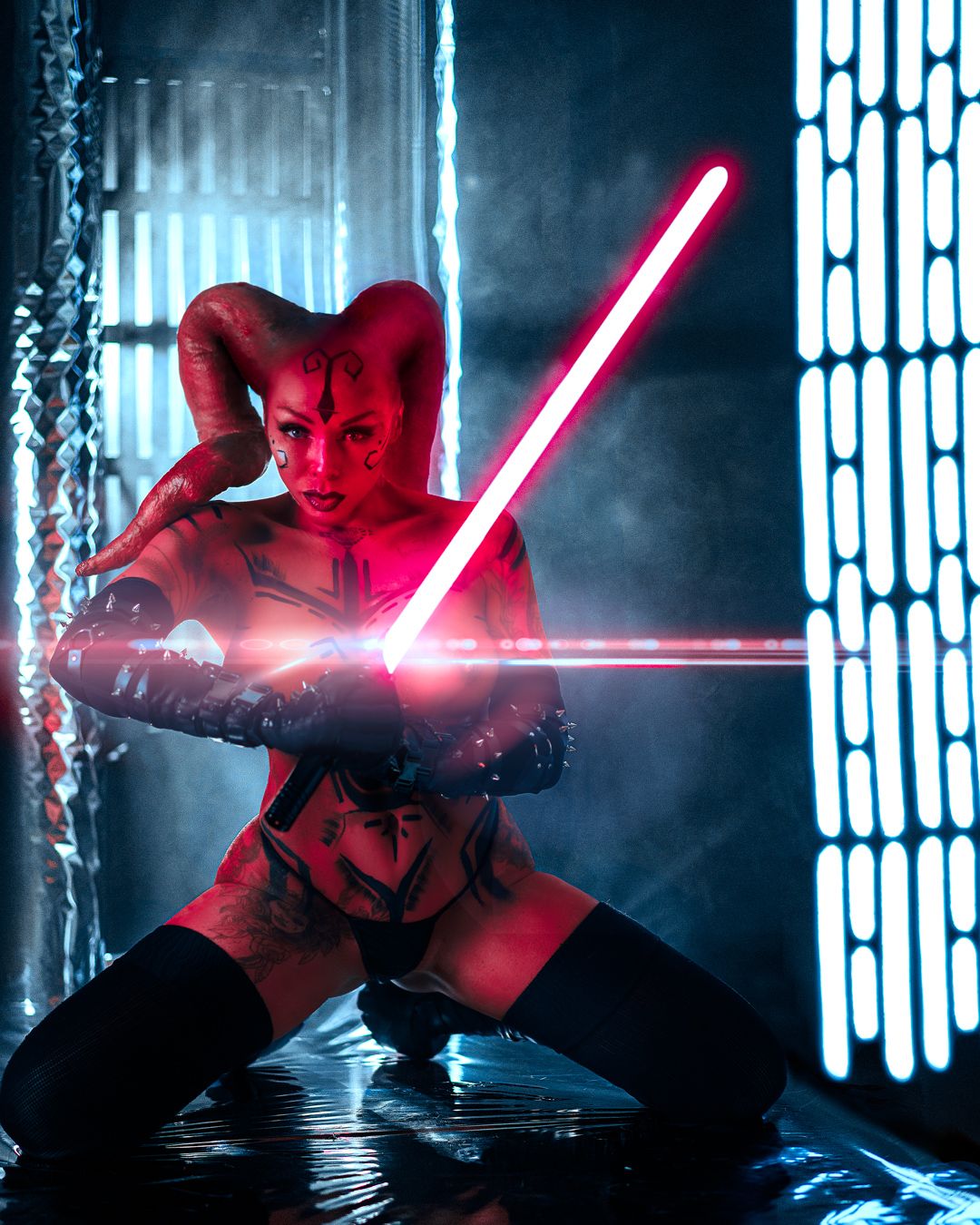 Cosplay photo featuring a red lightsaber and sci-fi corridor setting.