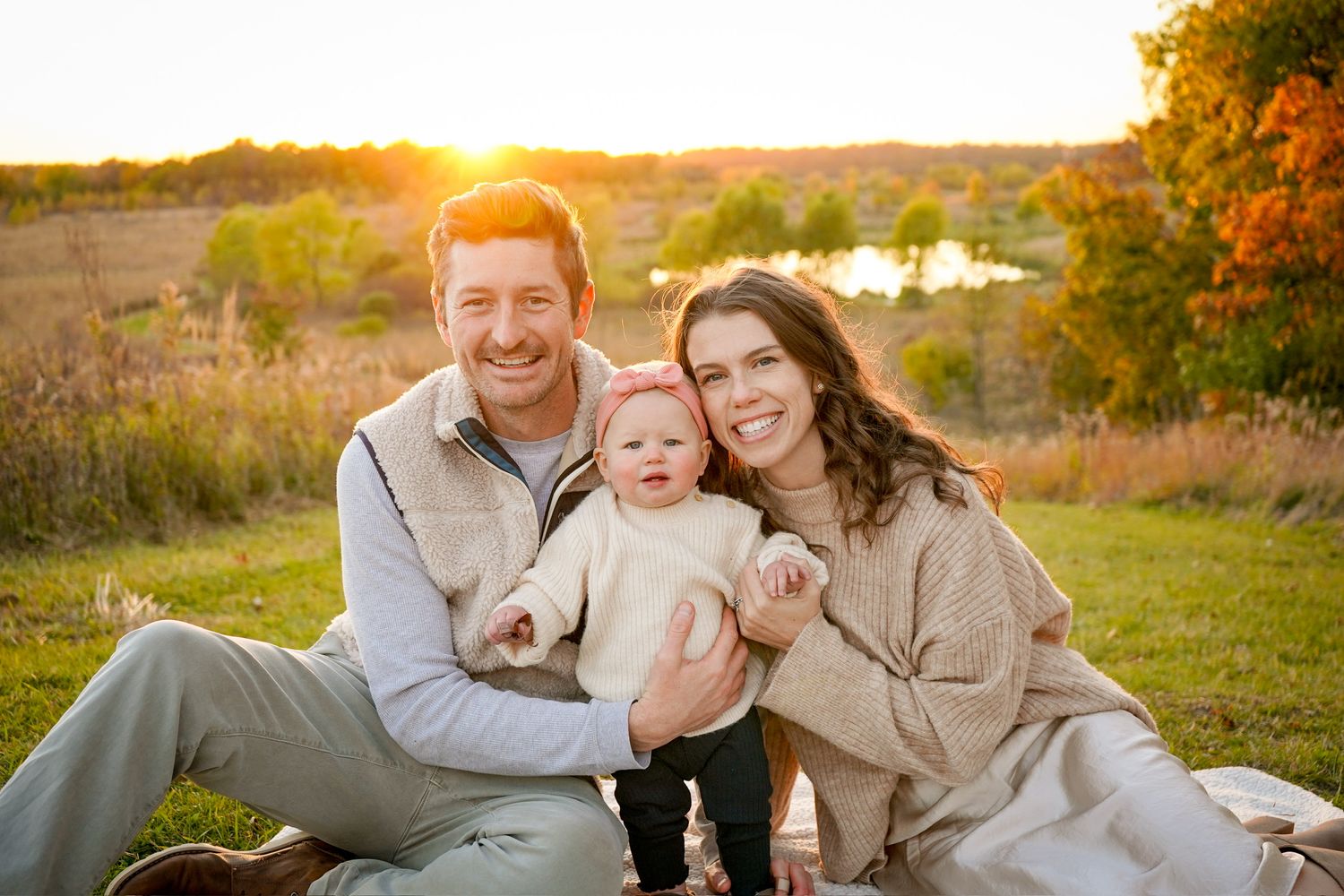 Family portrait session at sunset with warm autumn colors.