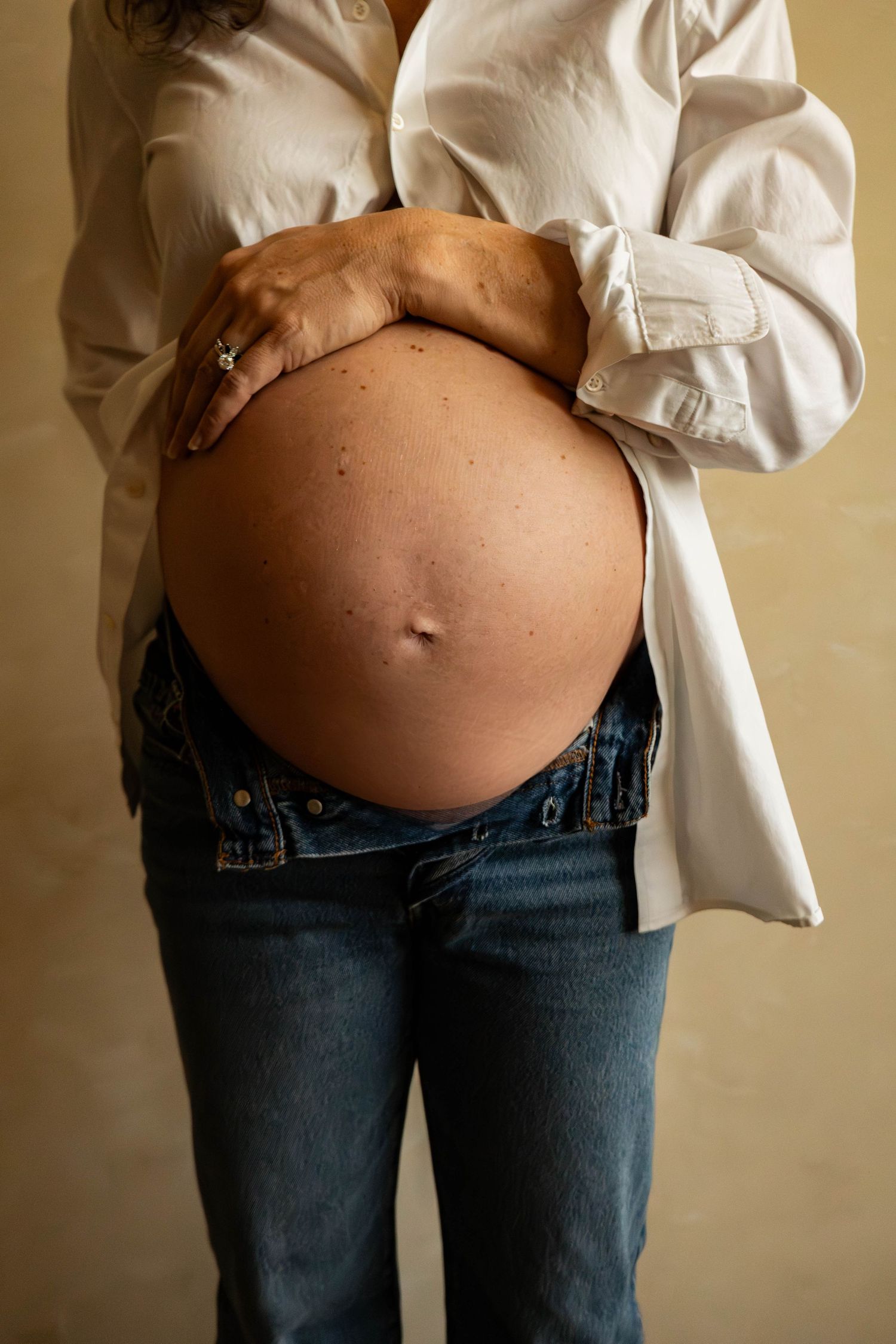 Sequence of maternity photos displaying pregnant belly against warm neutral background.