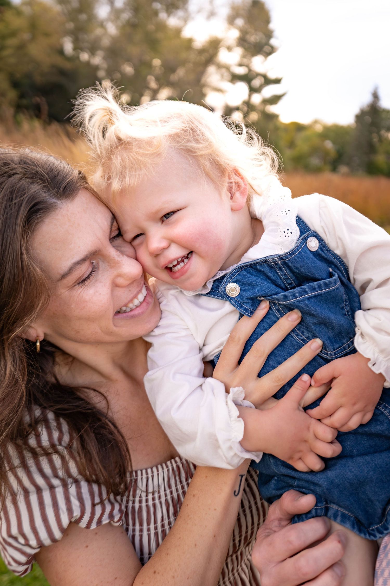 Playful sequence of a parent and child sharing loving moments together outdoors during golden hour.