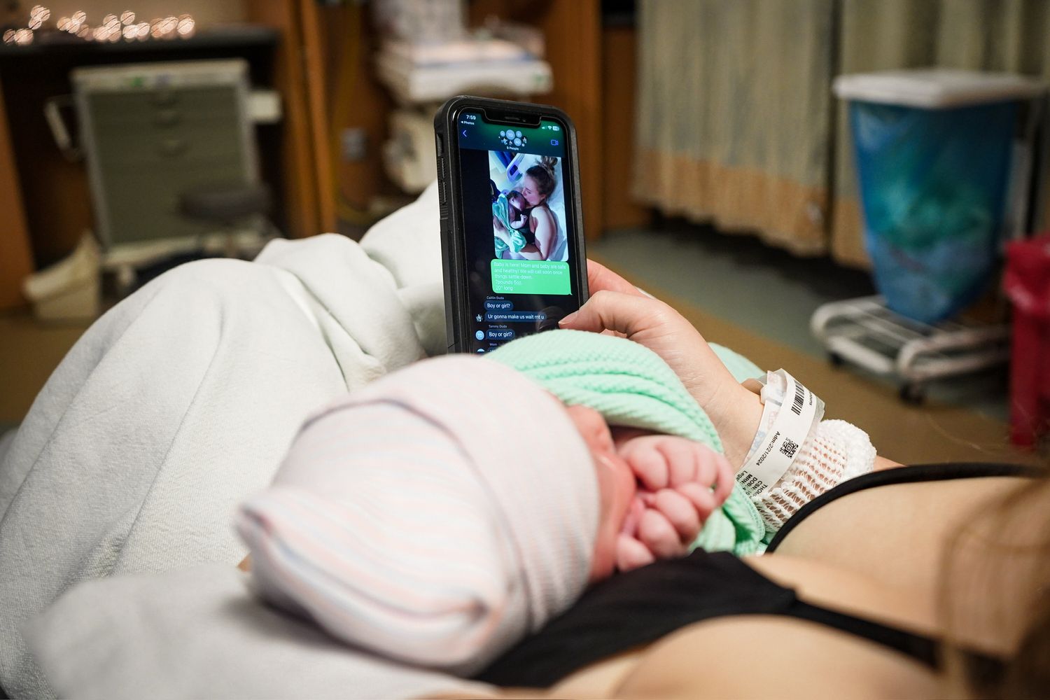 Hospital room view with mobile device displaying medical information.