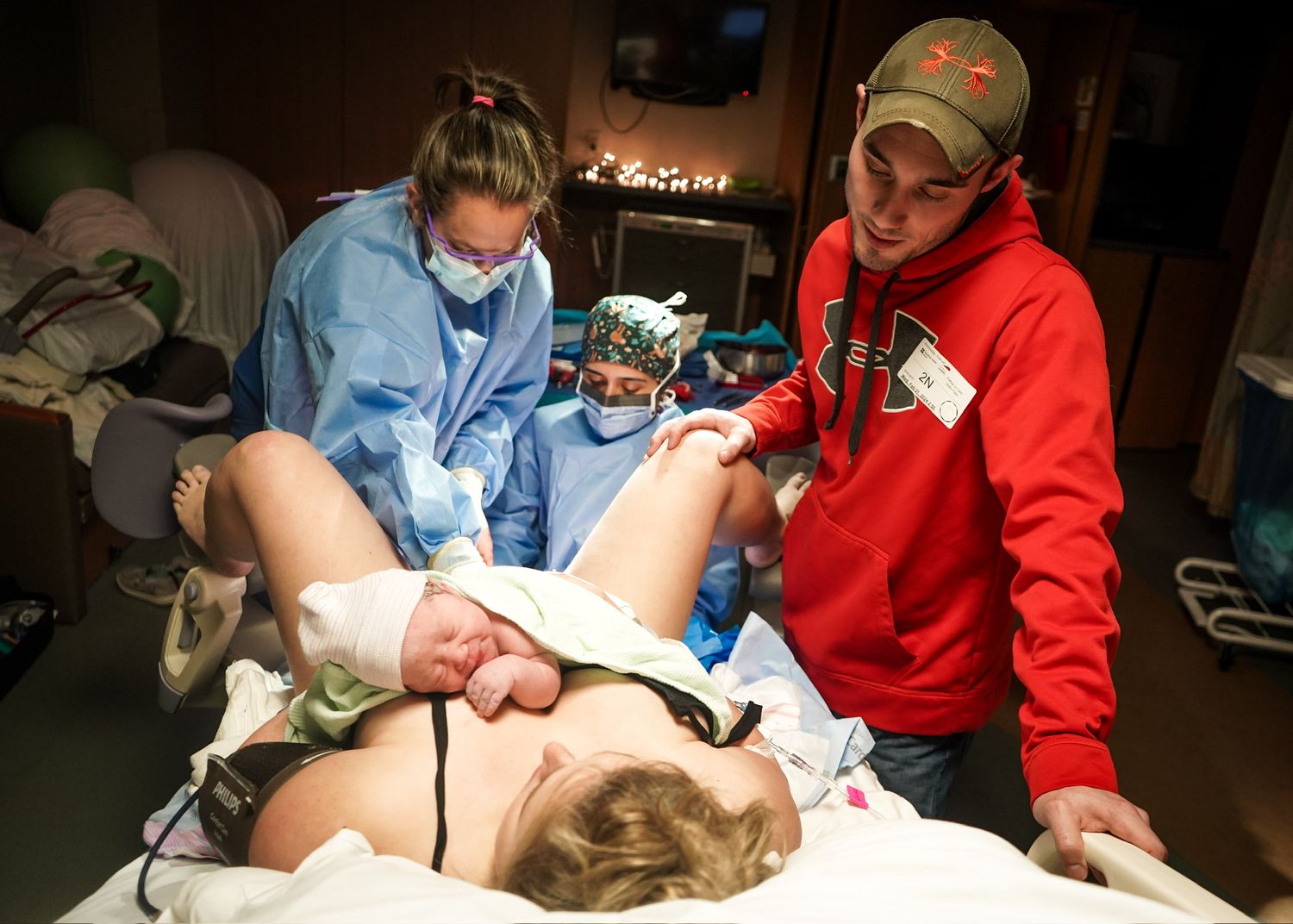 Healthcare team collaborating during medical procedure in clinical environment.