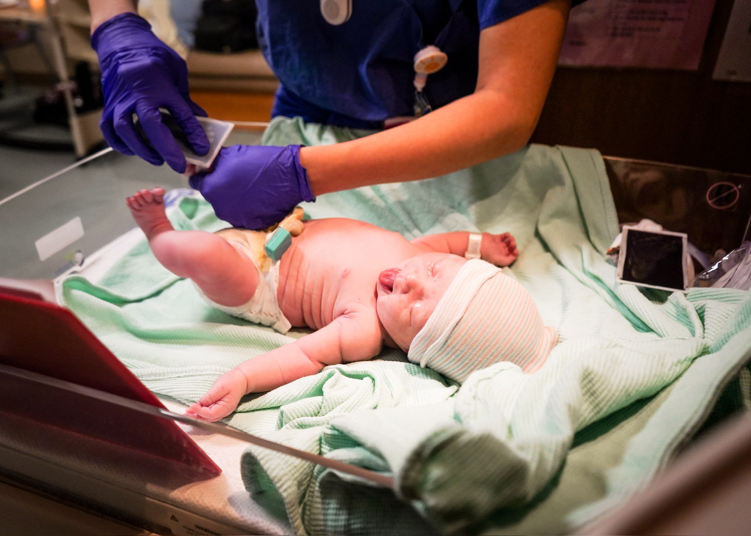 Medical staff performing examination or procedure in hospital setting.