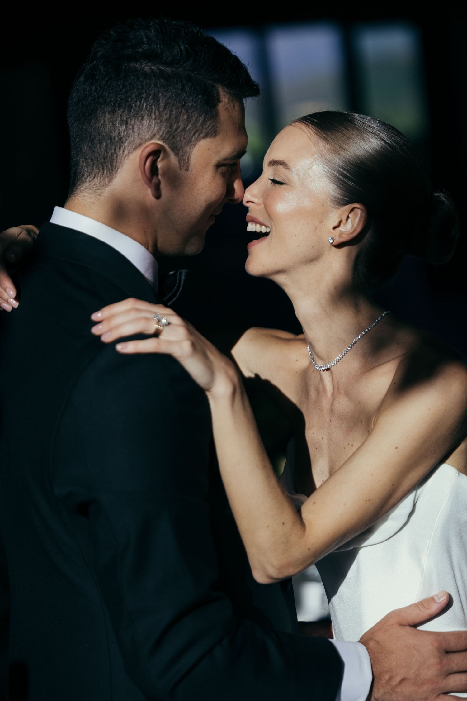 Romantic black and white wedding moment captured in intimate lighting.