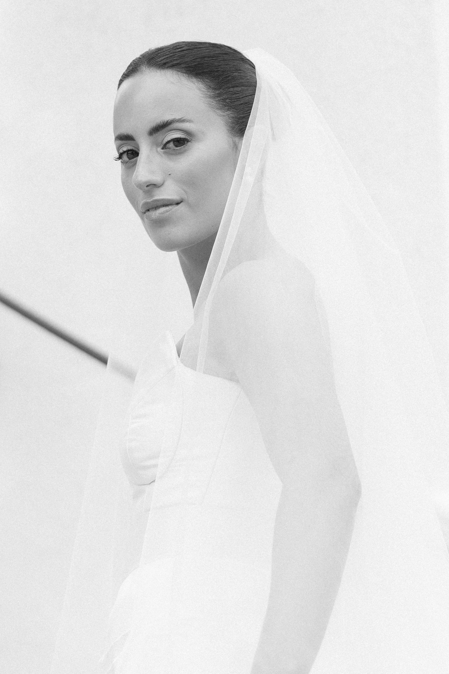 Ethereal bridal portraits in black and white showing a romantic veil sequence.