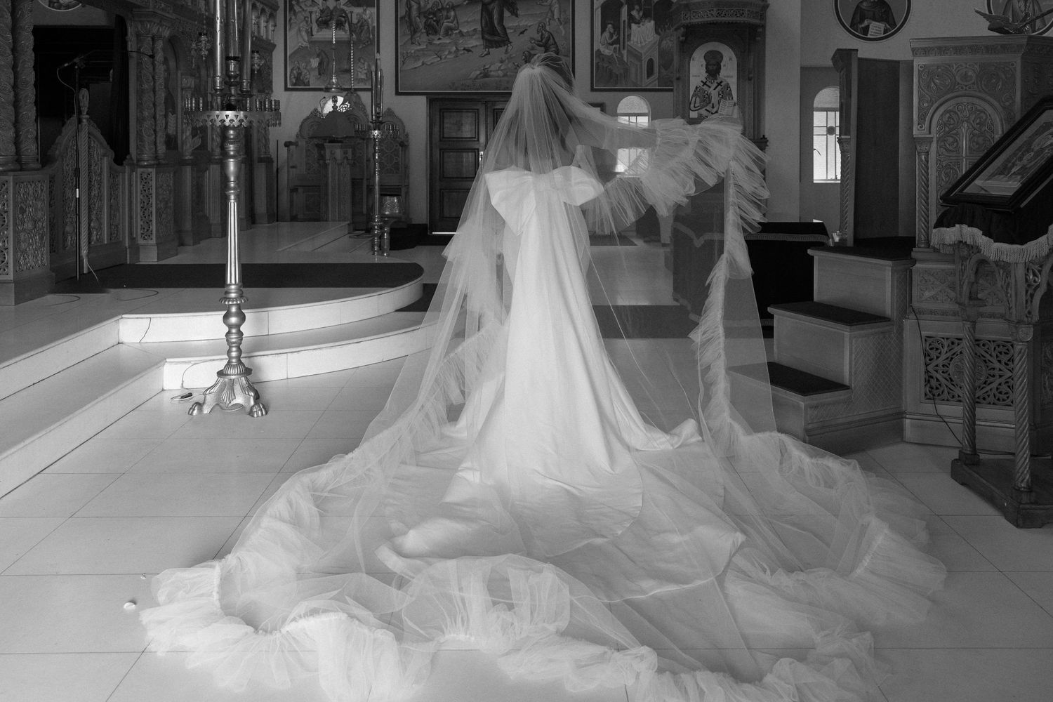 Long flowing wedding dress train photographed in an indoor venue.