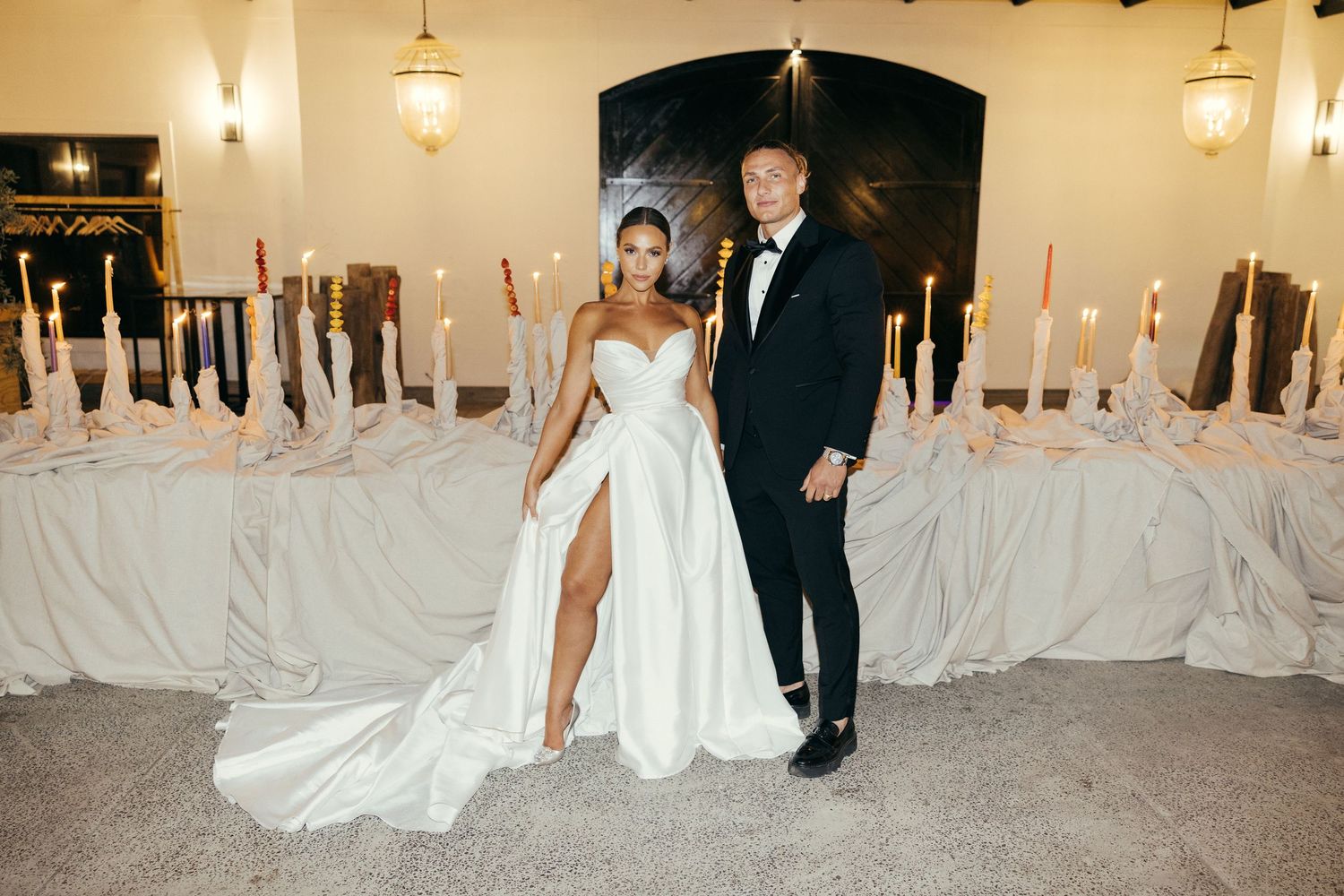 Elegant wedding reception setting with candlelit tables and sophisticated decor.
