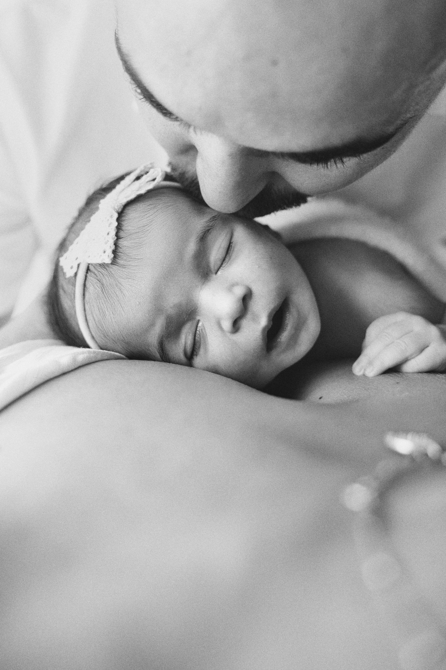 Tiny newborn being loved by mom and dad