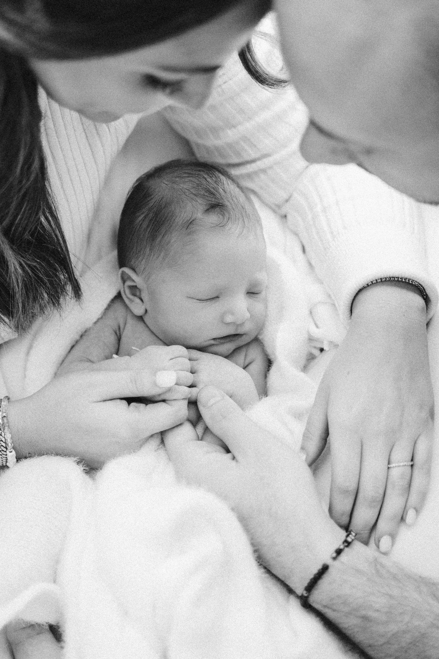 Soft newborn portrait with white swaddle and blue eyes open