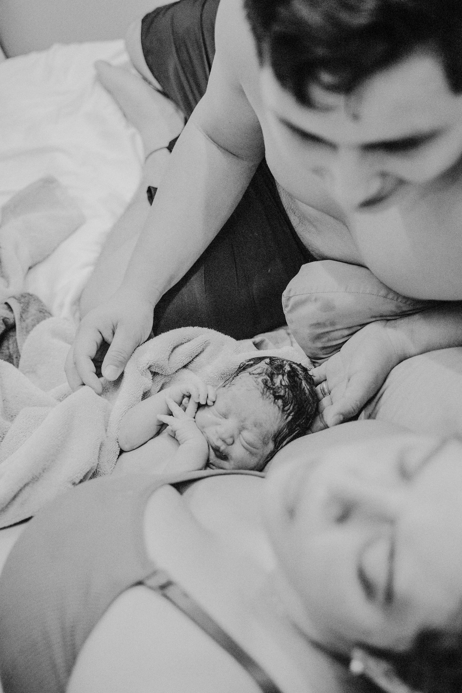 Hospital image of mom holding newborn baby shortly after delivery