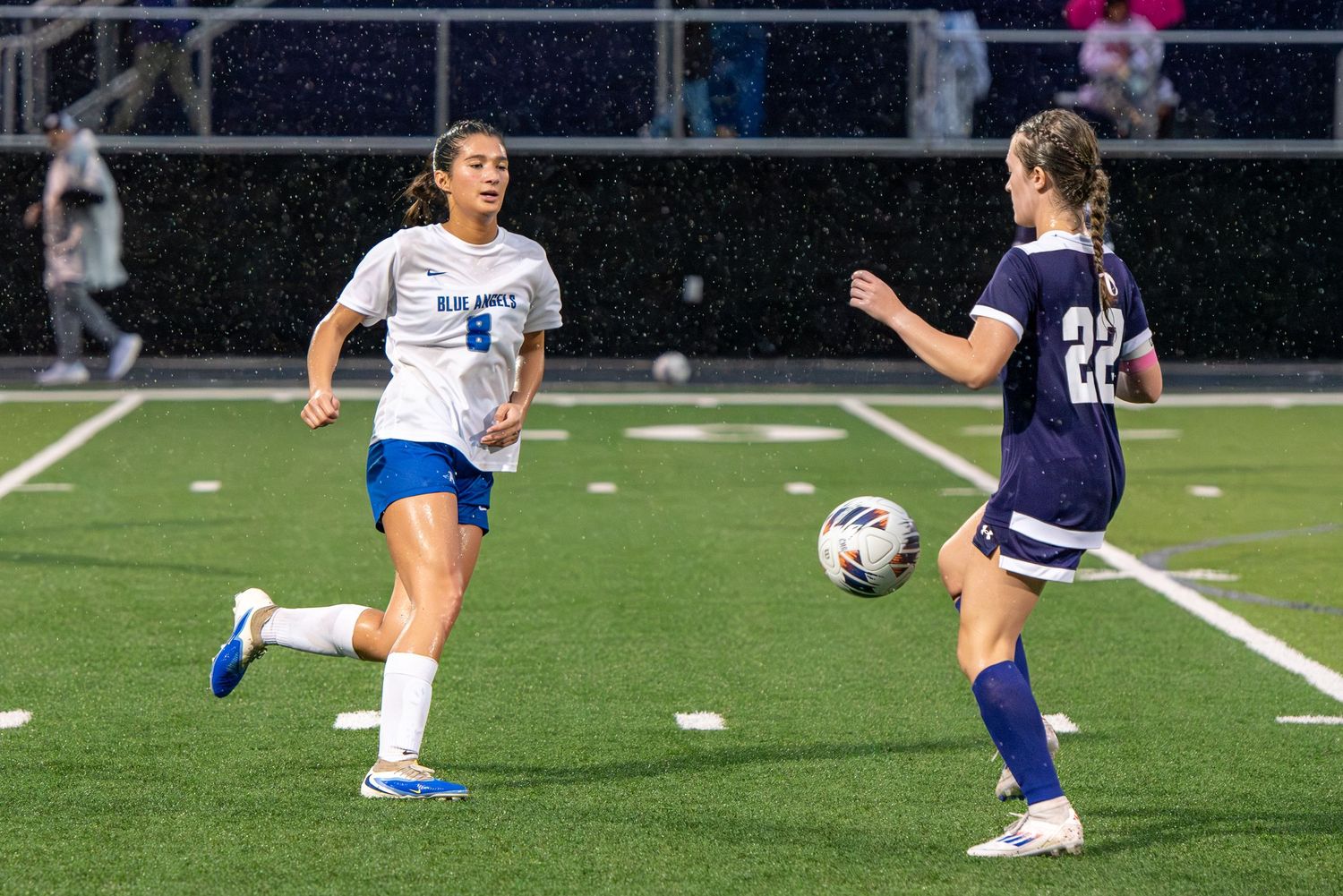 girls soccer in the rain