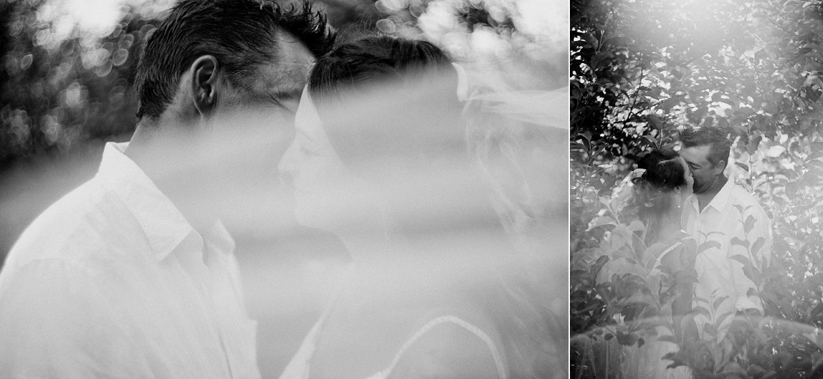 Black and white double exposure portrait of a man in a white shirt surrounded by soft bokeh and lush greenery.