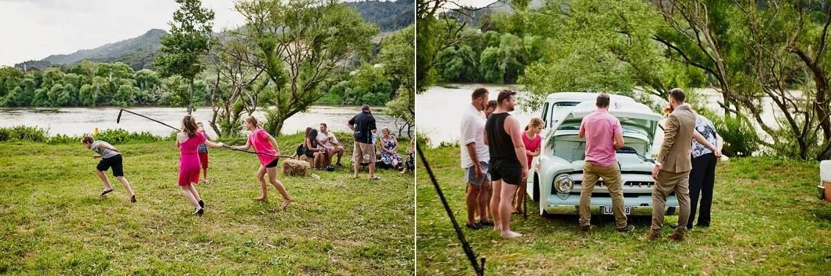 Guests enjoy outdoor wedding reception games and socializing by a scenic river with green hills in the background.