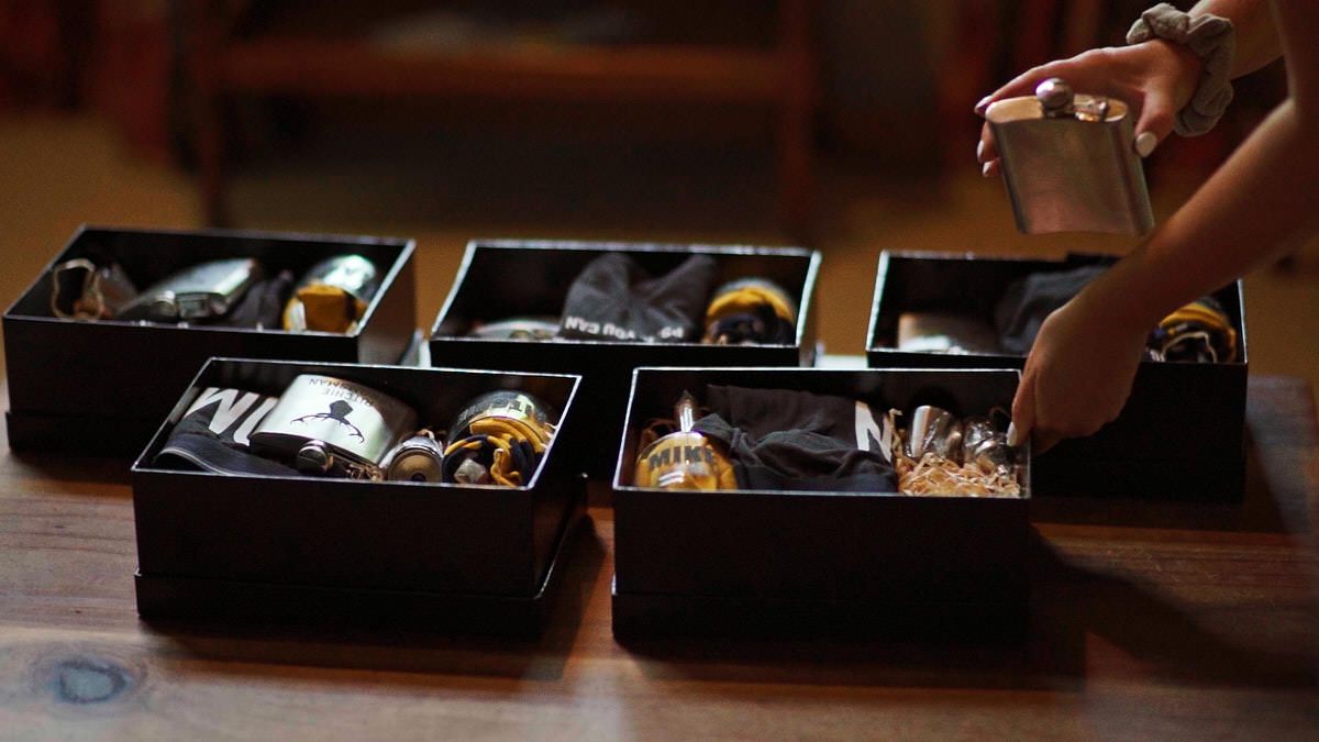 Black lacquer boxes filled with assorted bottles and trinkets displayed on a wooden table.