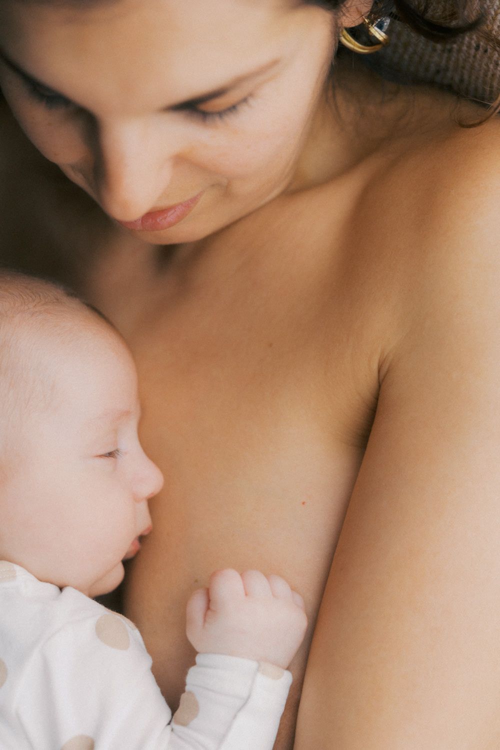 Mother breastfeeding her newborn baby, sharing a tender and intimate moment of bonding and nurturing.