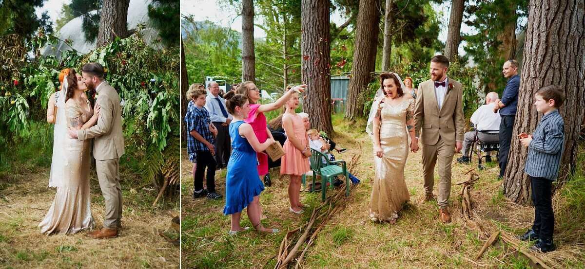 Wedding party celebrates outdoors among tall pine trees with guests in colorful attire.