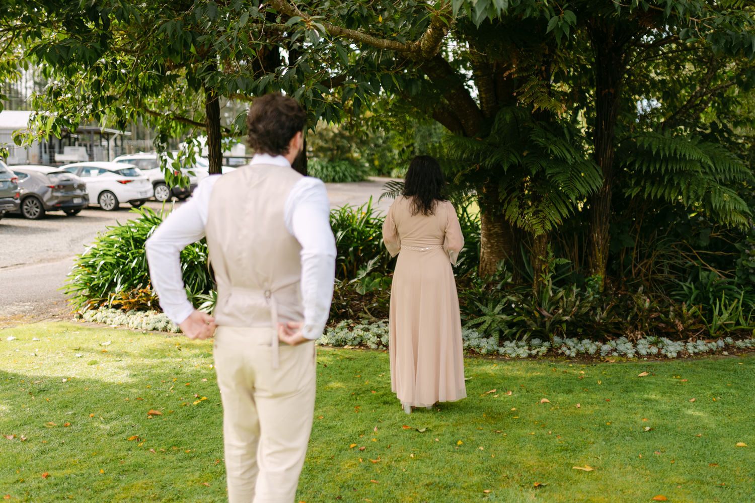 Bride and groom share a first look moment in a lush garden setting on their wedding day.