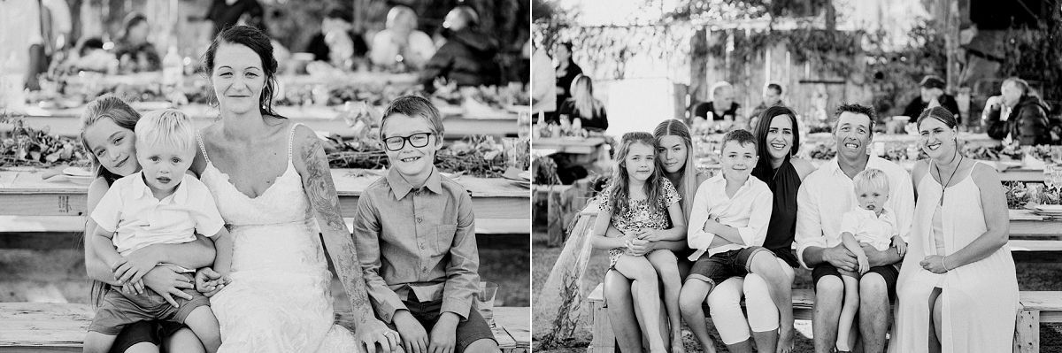 Black and white wedding photo of family groups posing outdoors at a garden celebration.