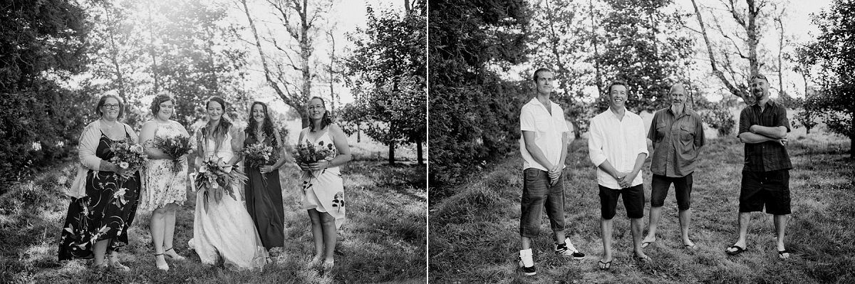Black and white photo of wedding party walking outdoors among trees after the ceremony.