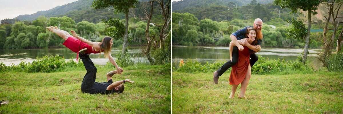Two people performing acro yoga poses outdoors near a scenic lake surrounded by lush green trees.
