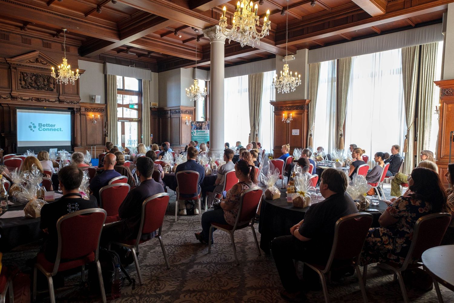 Corporate event in a wood panelled room.