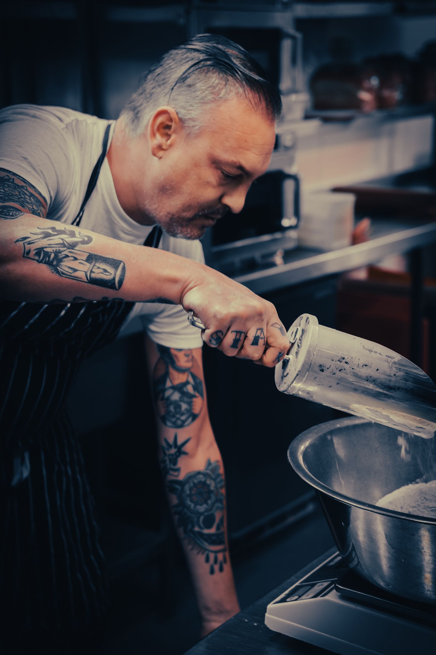 Candid portrait of a Leeds chef at work in the kitchen, photographed for Simon Robertson’s Shooting Chefs project.