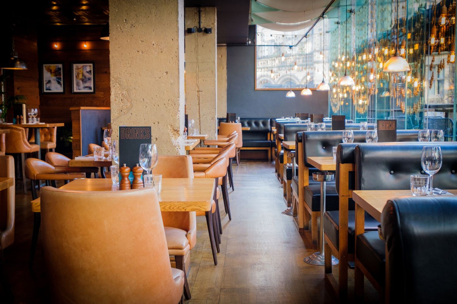 Atmospheric restaurant interior in Leeds showing dramatic window light shadows.