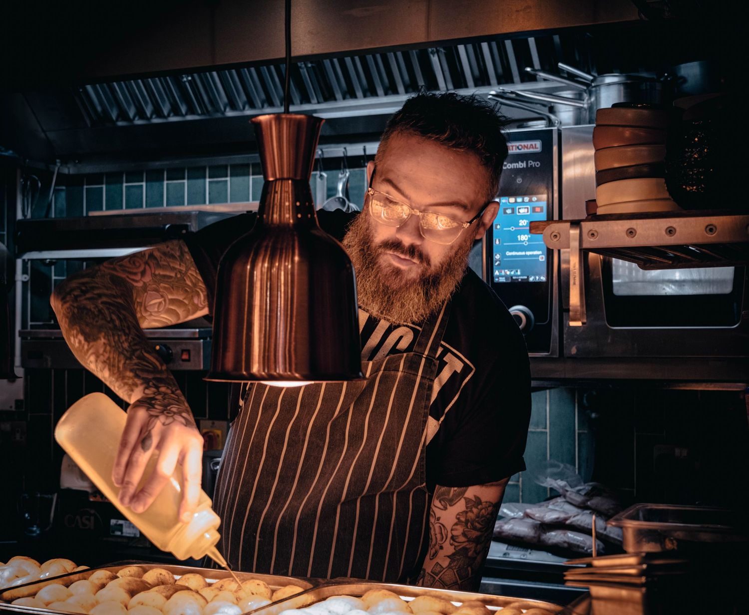 Candid portrait of a Leeds chef at work in the kitchen, photographed for Simon Robertson’s Shooting Chefs project.