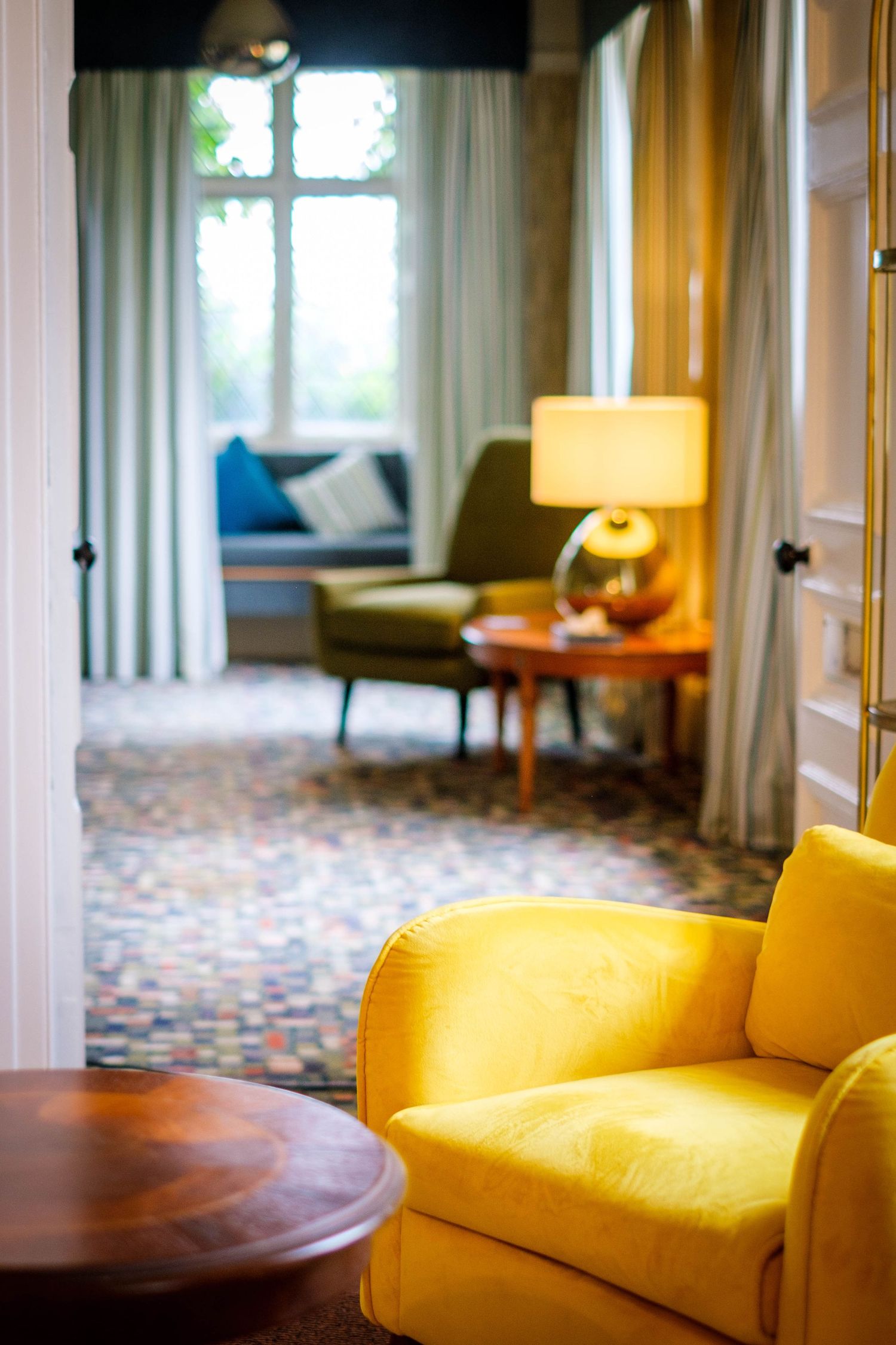 Classic reception room in a traditional hotel lobby, bright upholstered seating and a stylish wooden side table.