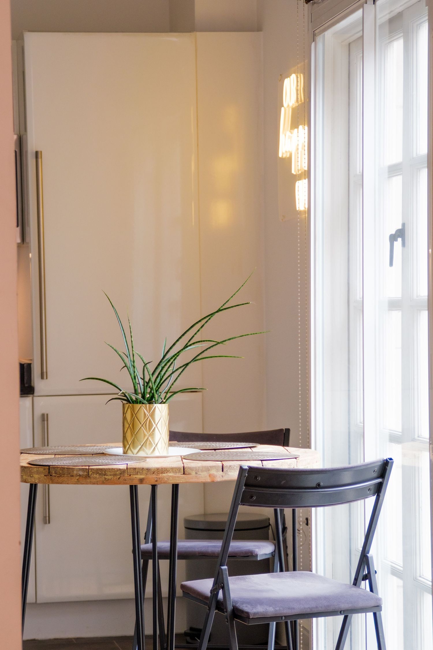 Modern kitchen remodel with white shaker cabinets, white marble countertops, and brushed brass hardware.