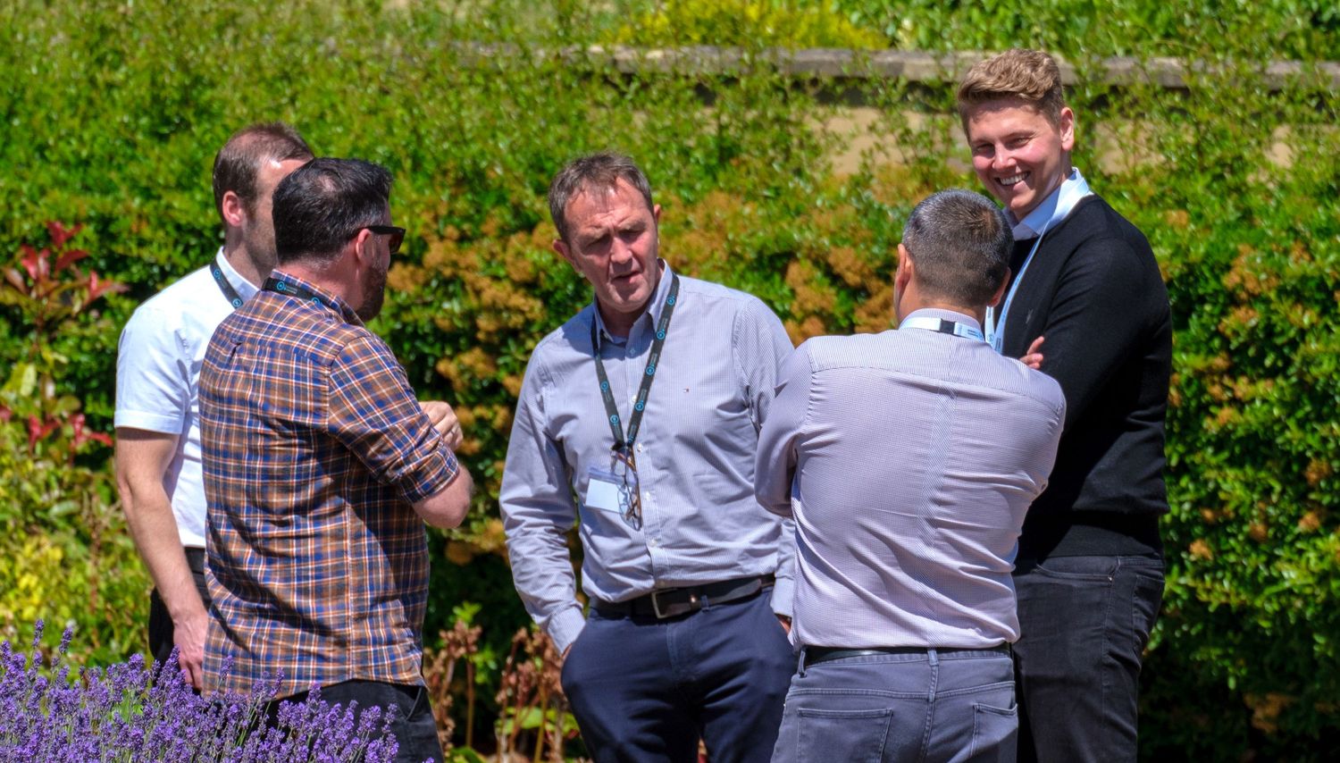 Team of diverse professionals collaborating outside during a strategy meeting.
