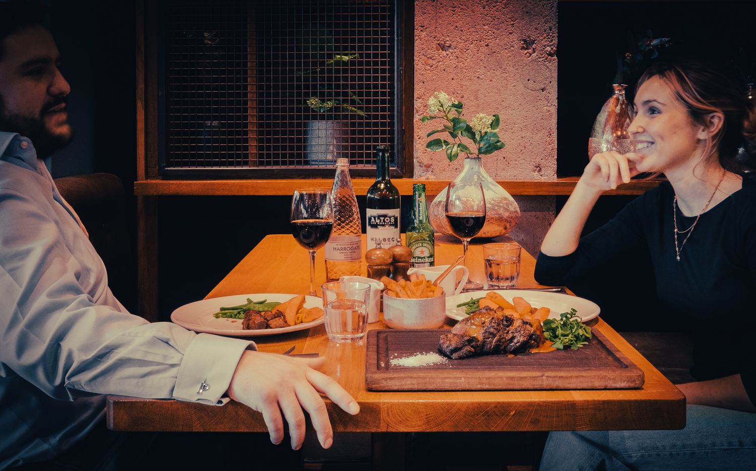 A couple enjoying a romantic meal in the beautiful surroundings of a city center restaurant in Leeds.
