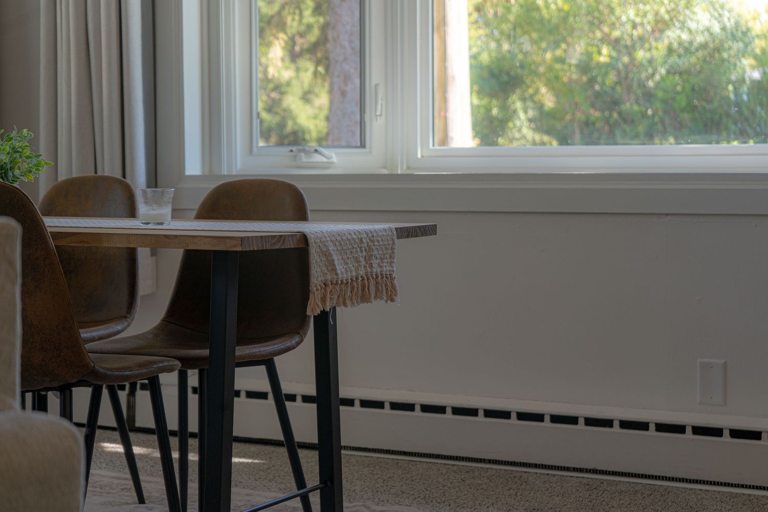 Modern dining area with large windows in a Chicago Airbnb
