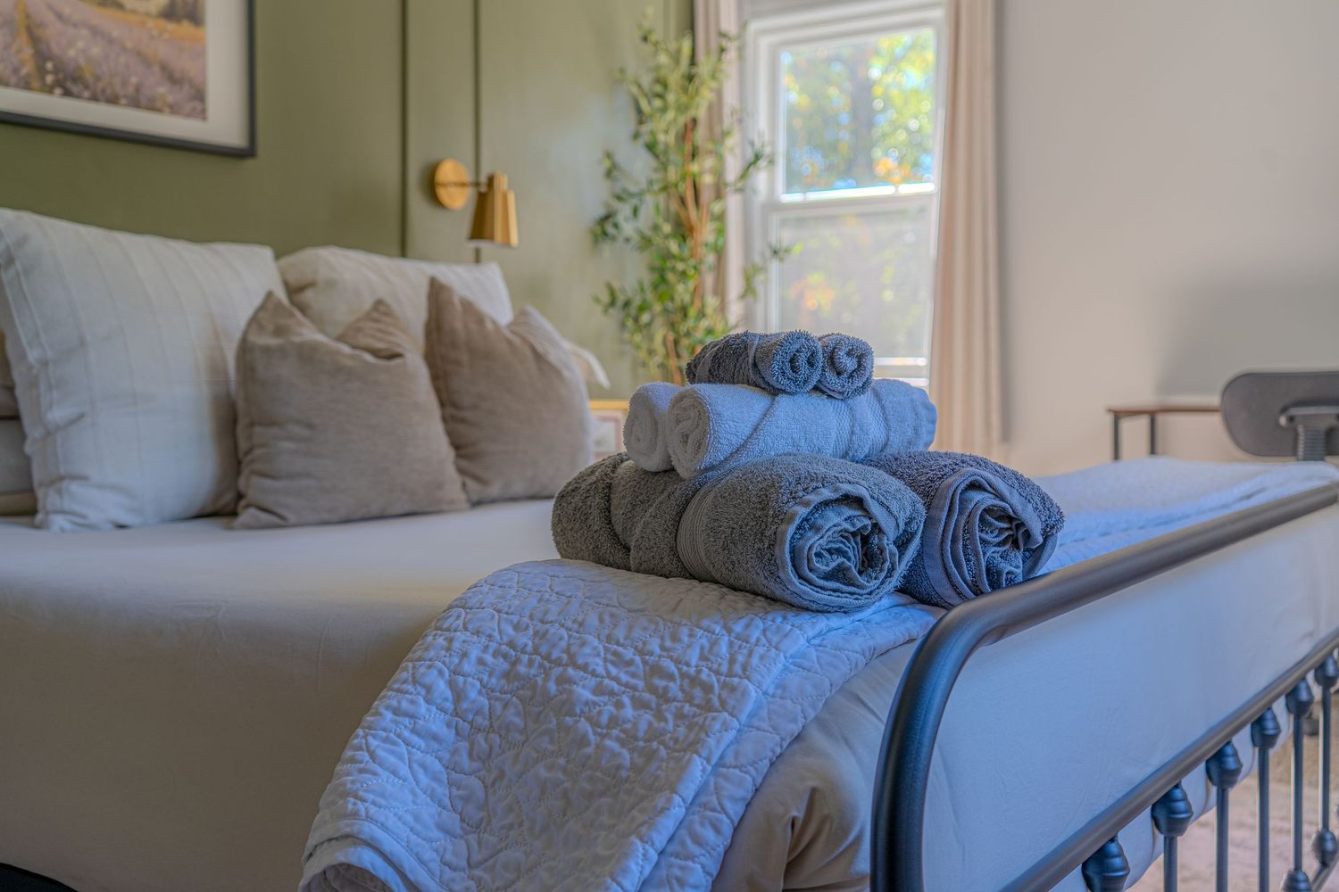 Cozy bedroom in a Chicago short-term rental with close up of towels pictured