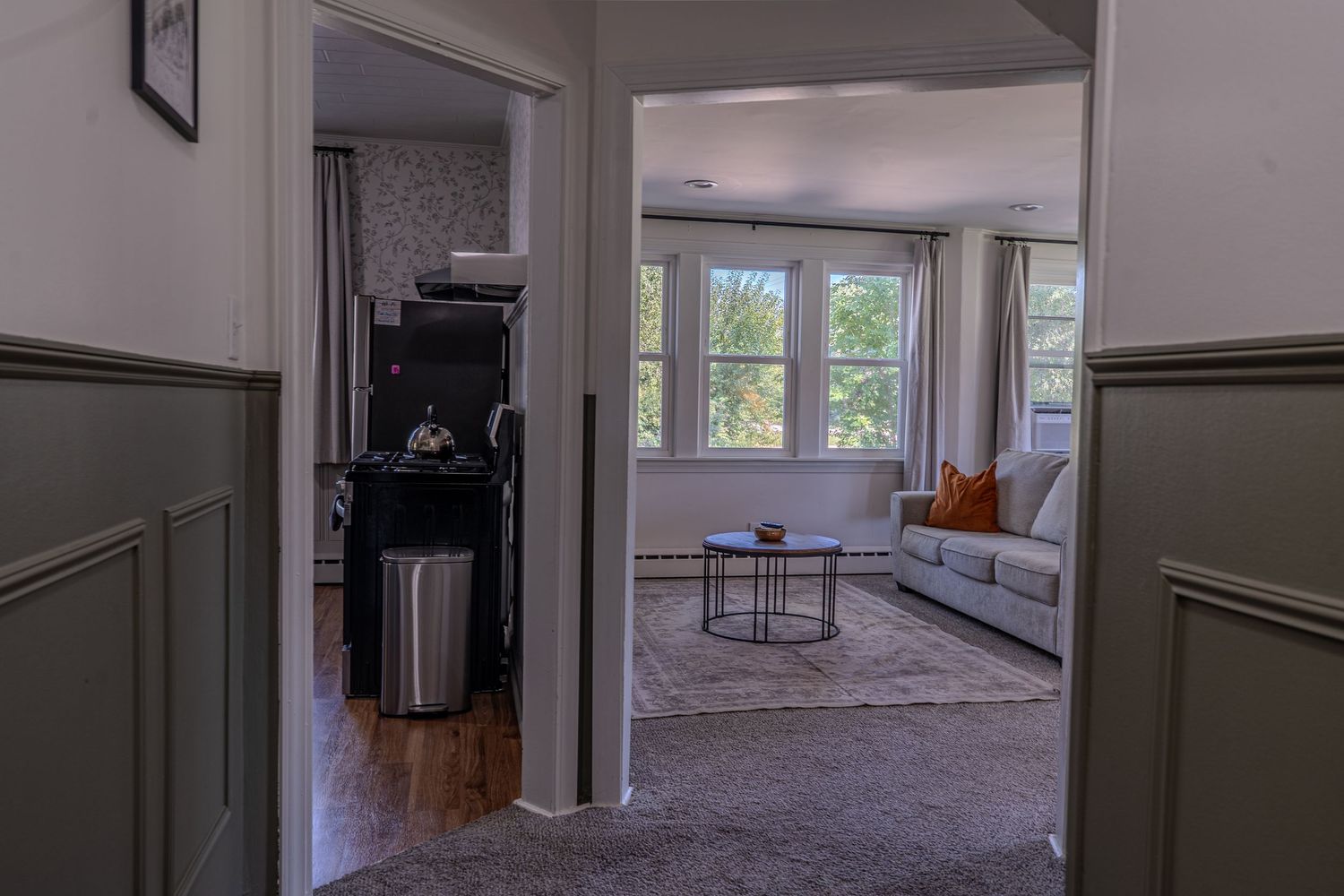 Modern hallway with views of living room and corner kitchen in chicago airbnb
