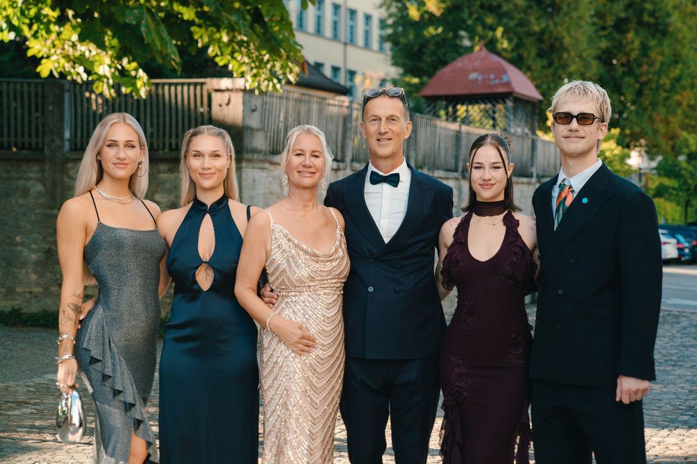 Group of guests in formal evening attire at an outdoor event
